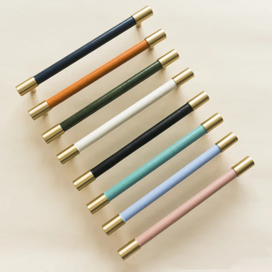 The handles are make of solid brass and leather. 15 colors of leather for options. The leathers are smooth and tightly attached to the brass bars.